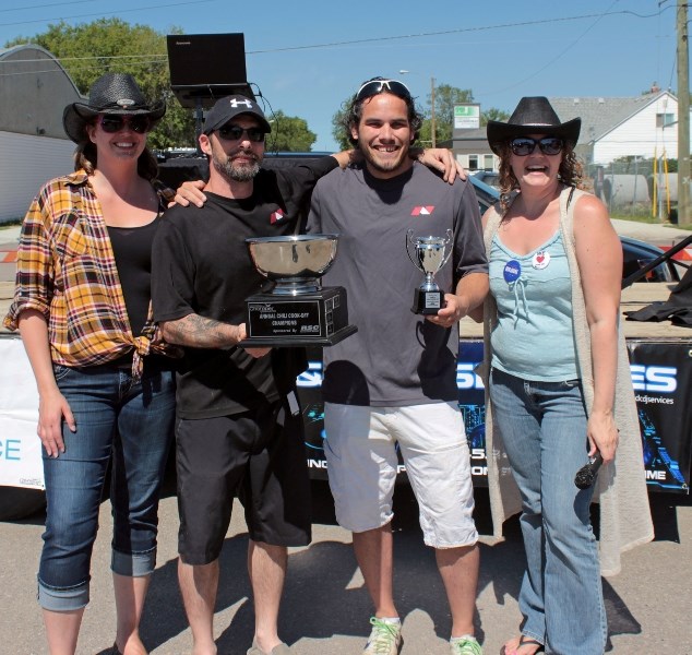 Chris Coyle and Jamie Mercier of Nelson Lumber accept their most sensational chili award from Tanya Oliver, executive director of the Chamber of Commerce, and Robyn Ducharme, 