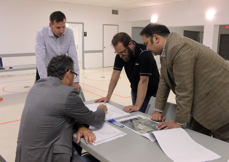 Cold Lake Mayor Craig Copeland and general manager of infrastructure services Azam Khan discuss the regional waterline route with Dema Land Services&#8217; Eric Laxdal, and