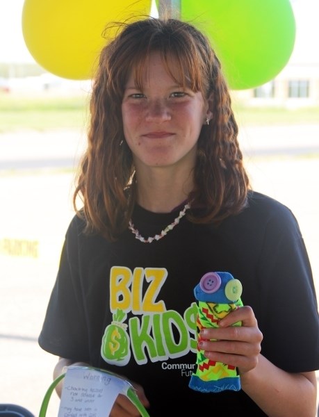 Lyvia Mongeau shows off one of her handmade squirmies that she had for sale throughout the summer with the Biz Kids program.