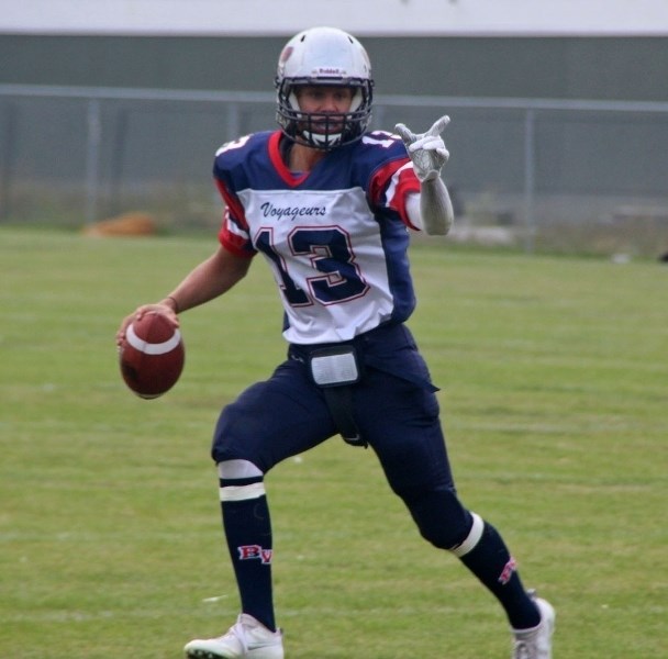 Quarterback Silas Fagnan points out his receiver before completing a 20-yard pass during the Voyageurs matchup with the Whitecourt Cats.