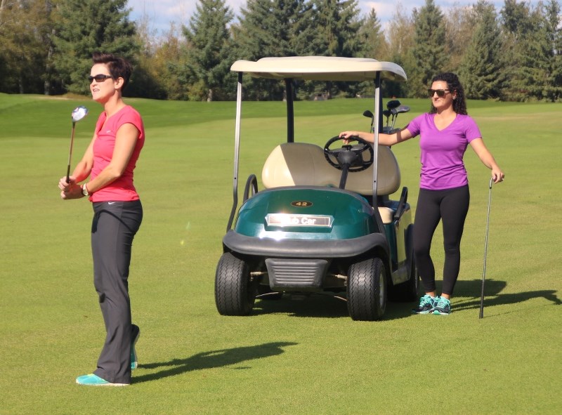 Alena Thompson and Marcelle Vallee watch Thompson&#8217;s shot sail down the fairway during the 2017 Ducharme Motors Charity Golf Tournament on Friday, Sept. 15.