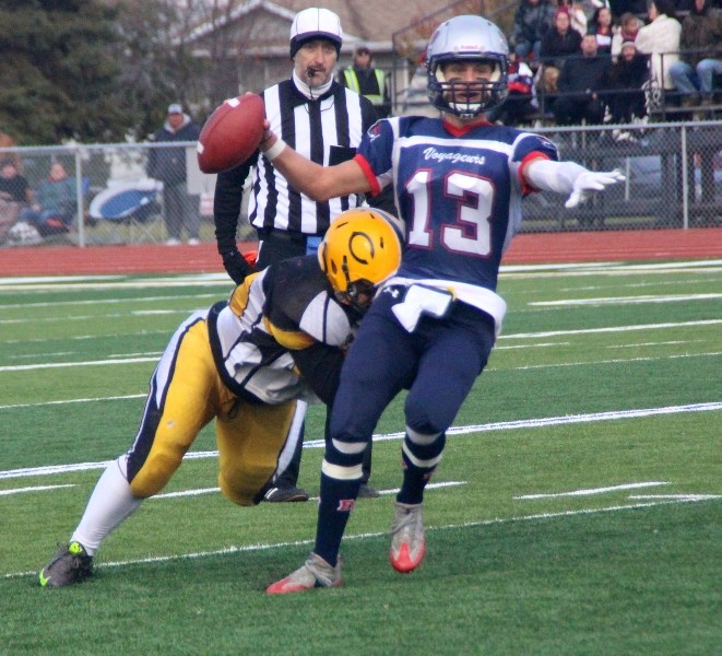 Bonnyville Voyageur Silas Fagnan attempts to get the ball out while fending off a Commandos tackler.
