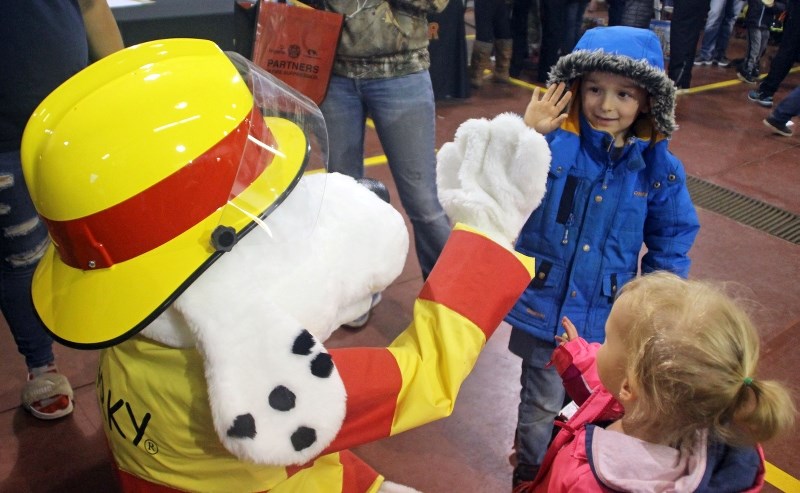 Ryder Herve and Ainsley Walzac hang out with Sparky at the BRFA Fire Prevention Open House on Tuesday, Oct. 10.