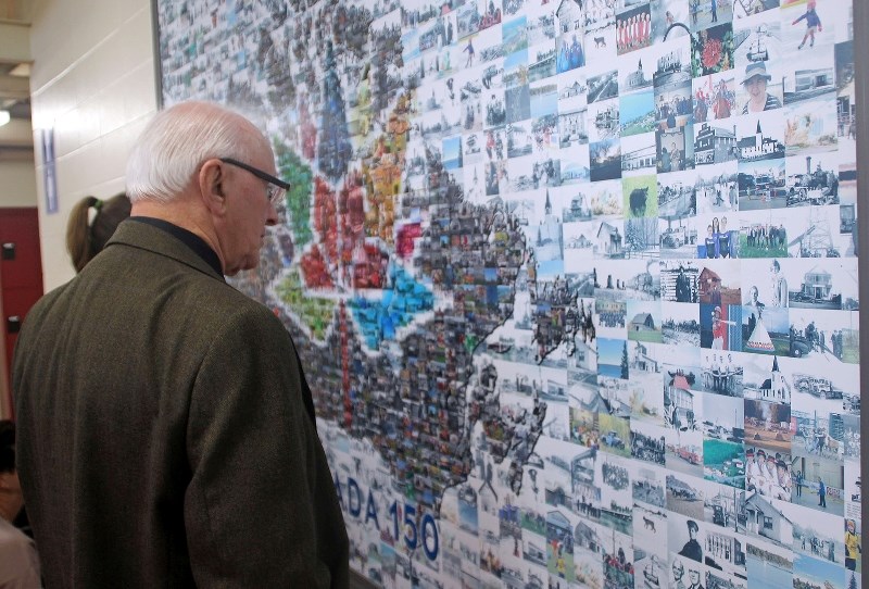 Town of Bonnyville Coun. Ray Prevost takes a close look at the newly unveiled Canada 150 mosaic, Saturday, Oct. 21.