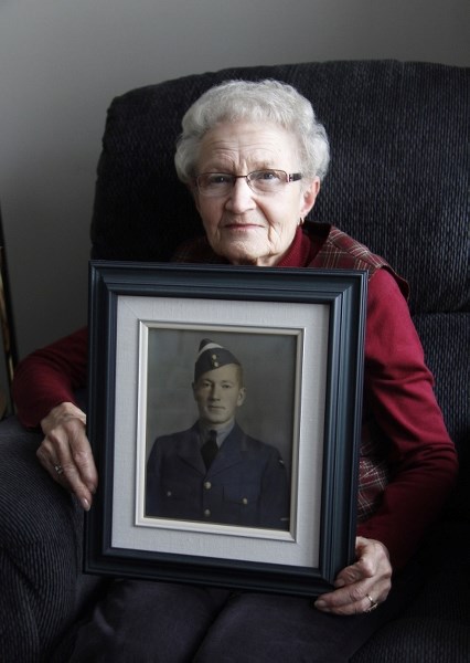 Pauline Marchand holds a photo of her brother Alexander Dunae, who passed away in the Second World War.