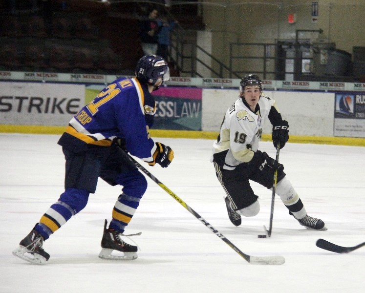 Carson Erdhardt dekes around a Fort McMurray Oil Baron during Saturday night&#8217;s game at the R.J. Lalonde Arena.