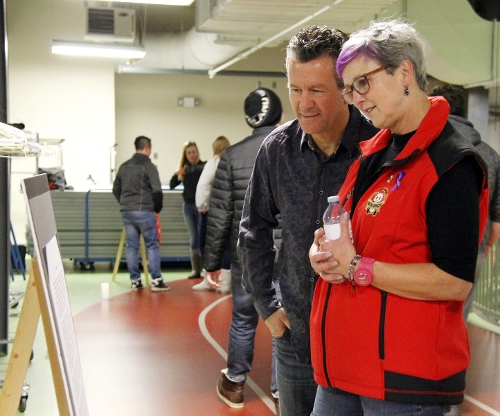 Cold Lake Mayor Craig Copeland and Anita from Cold Lake Victim Services, pause to read one of the stories along the Energy Centre track on Thursday, Nov. 16. The walk was