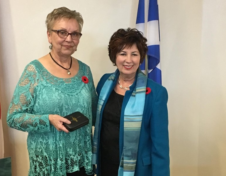 Claudette Proulx accepts her award from Senator Claudette Tardif.