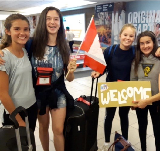 (left to right) Jacelyn Antoniuk, Ellyn Robert, Capucine Hardy, and Kristen Antoniuk meet at the airport.