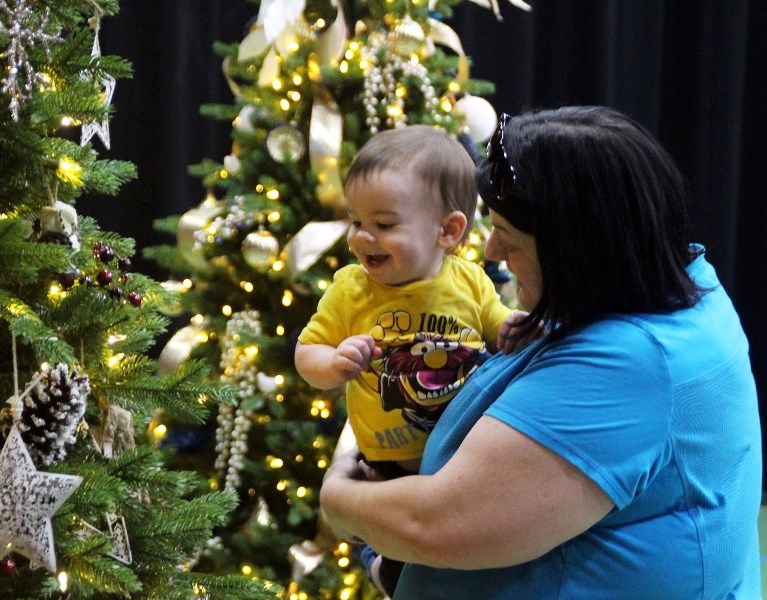 Rachelle Balla and Guillaume Gaulin admire the Christmas trees on display at the annual Festival of Trees Christmas Tea on Thursday, Nov. 30. The event was hosted from Nov.