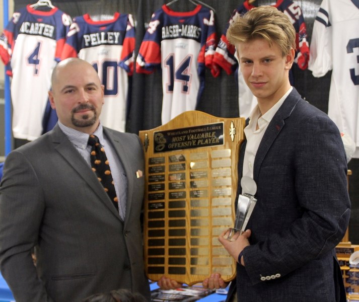 Head coach Larry Godziuk presents quarterback Silas Fagnan with the Wheatland Football League Most Valuable Offensive Player Award.