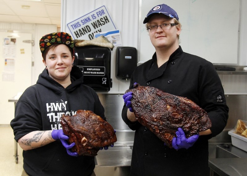 Chefs Yvonne Earhart and Robert Neumann have just pulled meat out of the smoker.