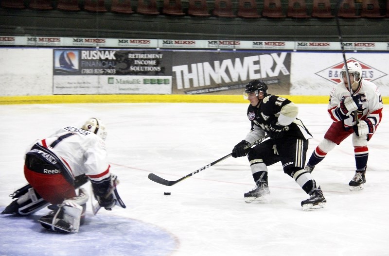 Isaac Saniga carries the puck up to the net during their game last Saturday against Brooks.