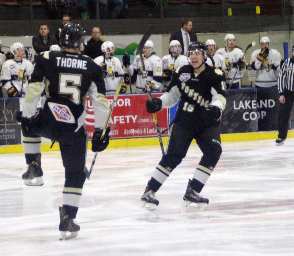 Lucas Thorne celebrates his third period goal with teammate Luke Albert.