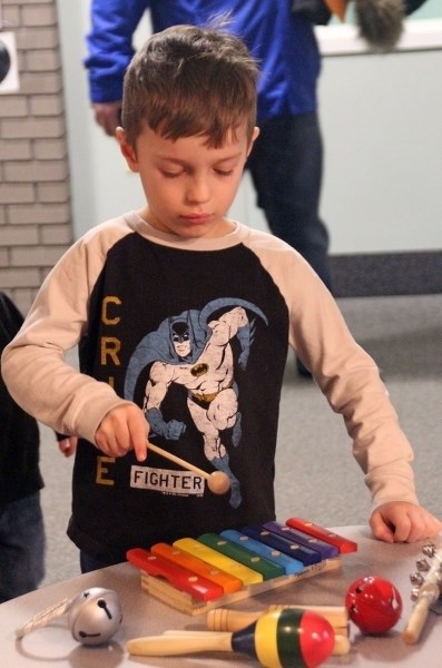 Colton Strzepek sharpens his musical skills on the xylophone during Family Literacy Night.