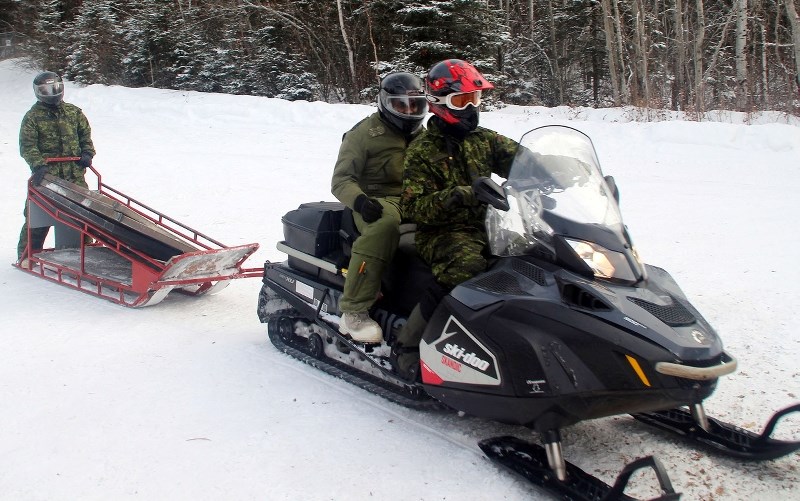 Capt. Jani Athukorala (centre) gets a ride back to camp after spending two nights in the wilderness.