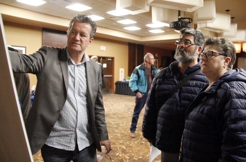 Cold Lake residents Pat and Denis Laurin listen to Mayor Craig Copeland explain the finer details of the annexation area during the open house at the Best Western Inn in Cold 