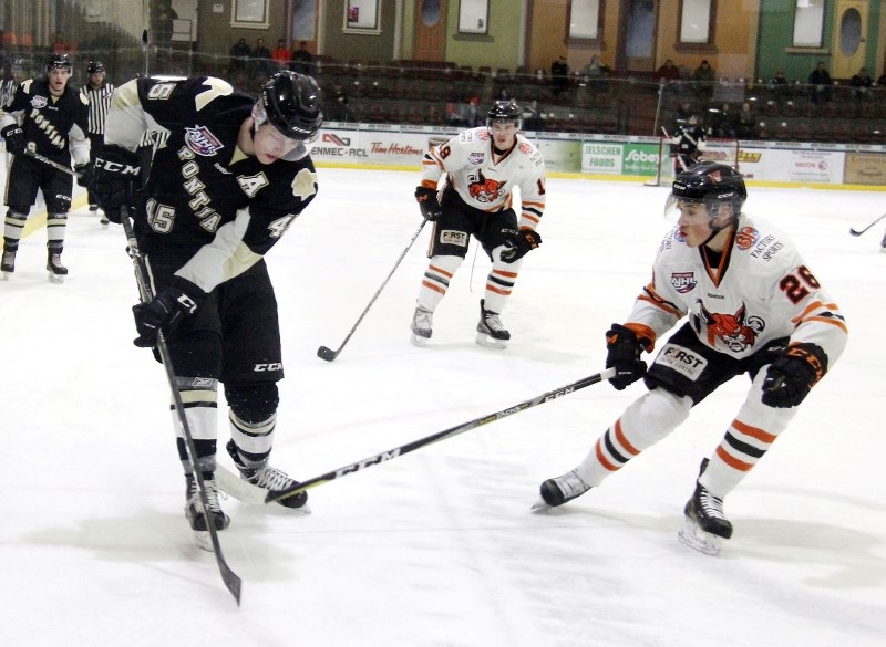 Luke Albert gives the puck a kick as he skates his way towards the Bobcats net in the second period during their game against Lloydminster on Saturday.