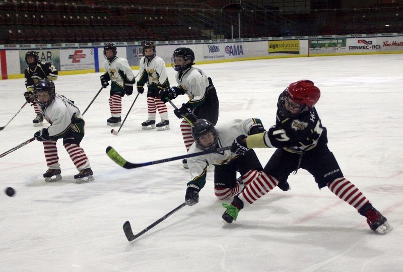 Peyton Houle (far right) fires a shot past an outstretched Bashaw player.