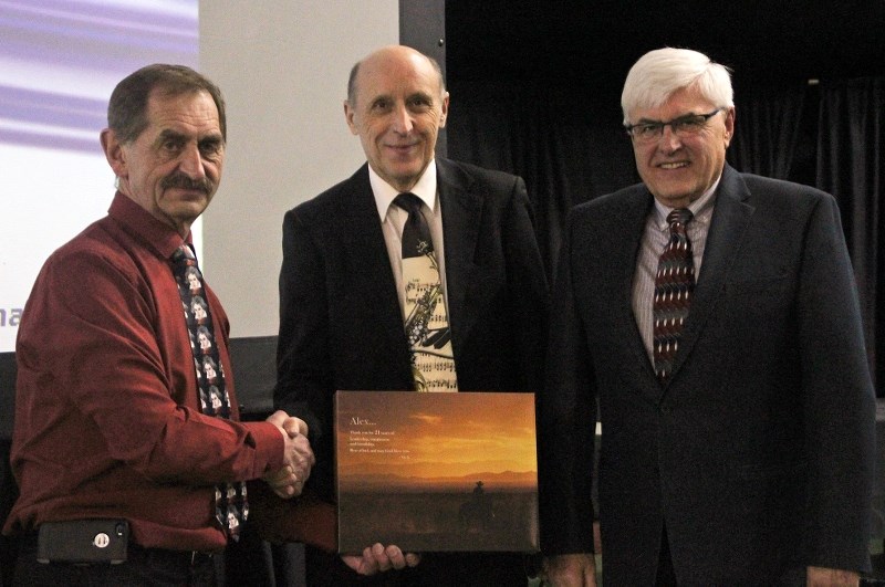 Bonnyville Covenant Health Centre administrator Alex Smyl (left) accepts a token of gratitude from gala MC Vic Sadlowski (centre) and health foundation chair Roy Doonanco