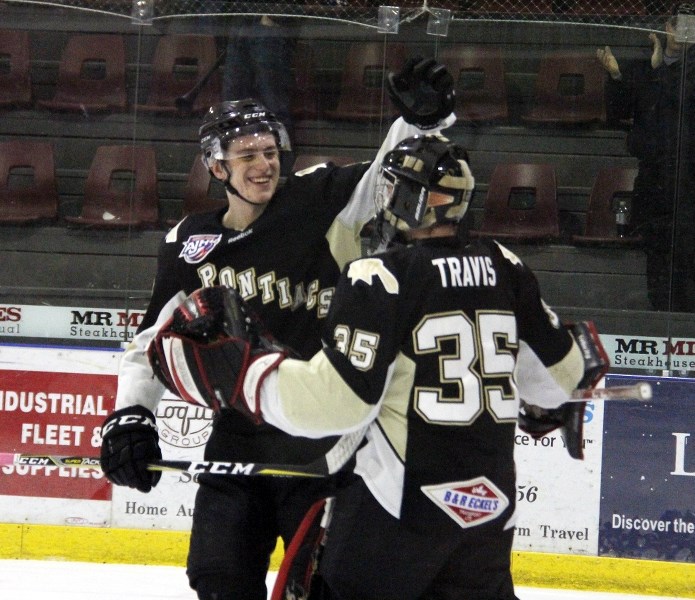 Kirby Proctor congratulates Pontiac goalie Justin Travis on his shutout that landed the team a spot in the playoffs.