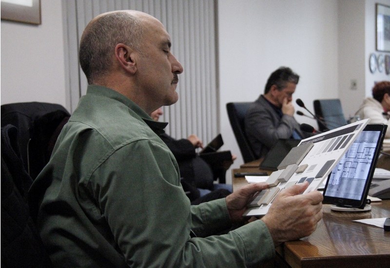 Coun. Kirk Soroka looks over the materials being used for the grandstand.