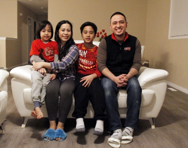 The Dacullo&#8217;s sit in the living room of their new home. They were recently handed the keys to Habitat for Humanity&#8217;s first single-family residence in Cold Lake.