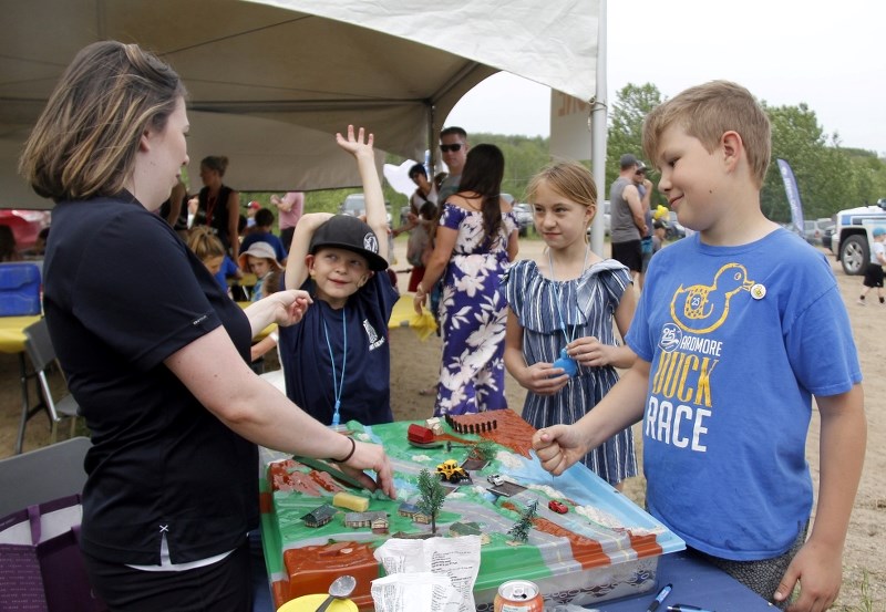 Erin Ritchie, education coordinator for LICA, explains to a group of kids at a local event the importance of the Beaver River Watershed.