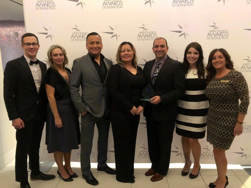 Representatives from Seven Lakes stand with members of the Cold Lake Regional Chamber of Commerce after accepting the Eagle Feather Award of Distinction.