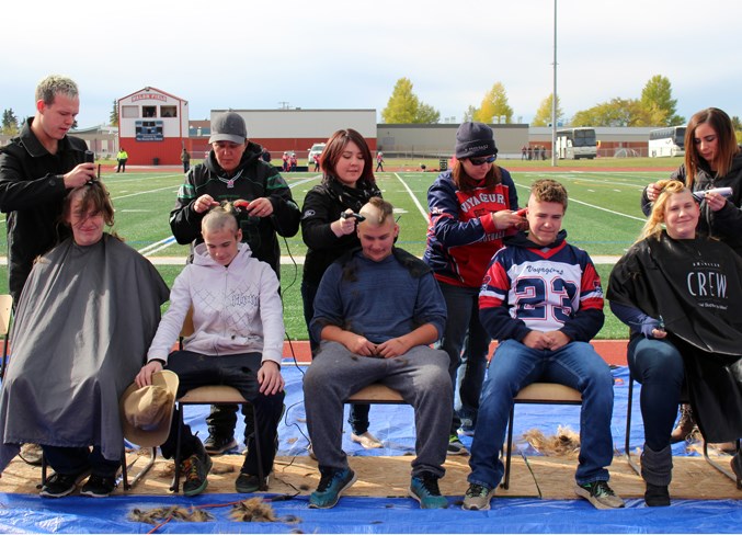  Local football players shaved their heads as part of the Scott MacDonald Memorial Tournament on Saturday. Players collected donations for cancer research.