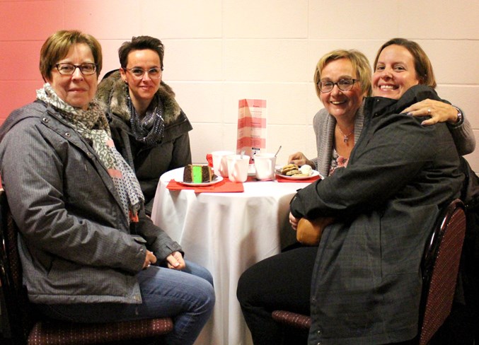  Angele Ducharme (back left), Paula Brosseau (front left), Cathy Ducharme (front right), and Genia Leskiw (back right) enjoy some hot drinks and sweets during the Fair Trade Market.