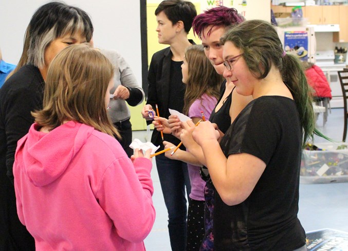  Eleven-year-old Zoe Demore (left) asks Victoria Lenton, 12, (right) if she’s the one that wrote the answer on her paper during an icebreaker activity.