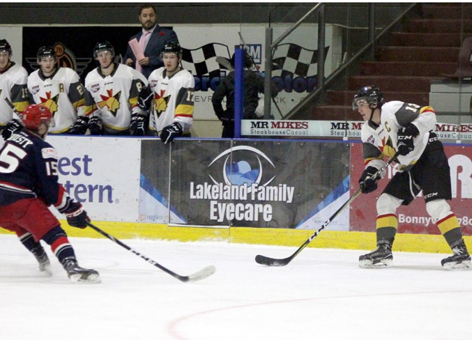  Grayson Constable keeps the puck away from the Brooks Bandits during the game.