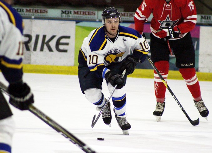  Dru Morrison carries the puck down the ice during their match-up.