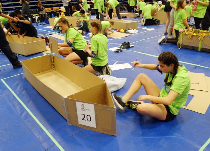  Students from H.E.B. show off their boat building skills.