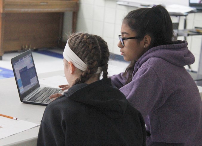  Chloe, Grade 7, and Julia, Grade 8, work on their code.
