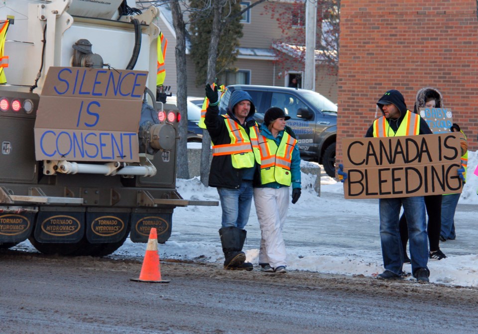  Protestors held their signs up for oncoming traffic.
