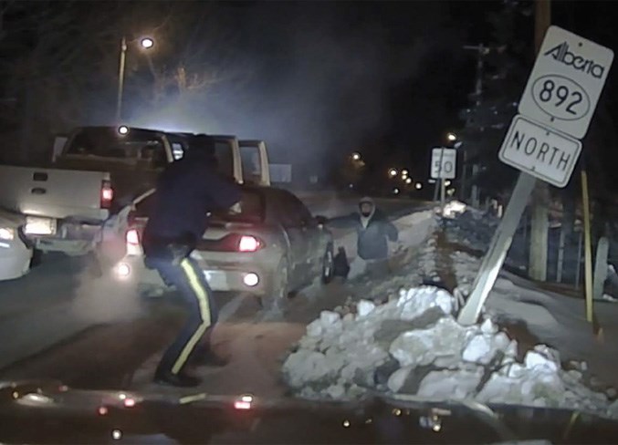  An officer arrests one of the suspects.