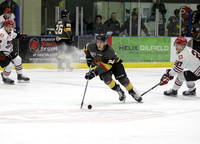  Trey Thomas keeps his eye on the Whitecourt Wolverine’s goal as he makes his way across the ice.