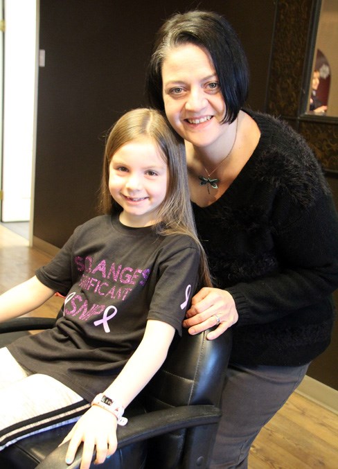  Solange and Rachelle Balla pose for one last photo before the big snip.