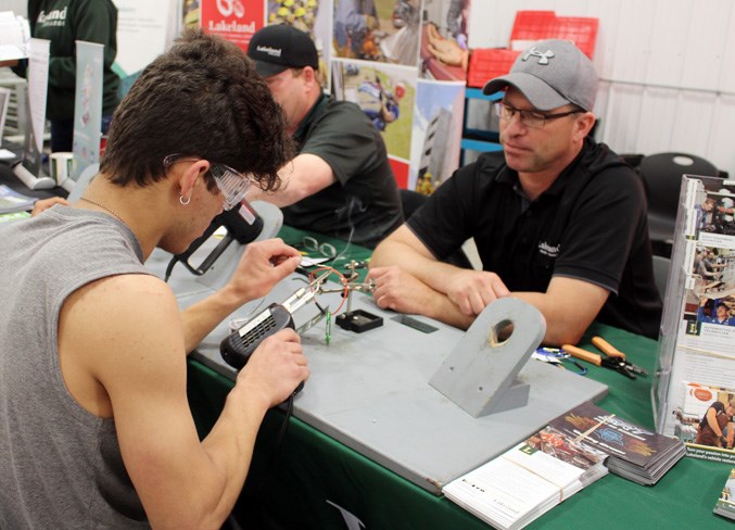  Mike Rozka (right), lab technician at Lakeland College, gives Grade 10 CLHS student Dylan Willder a few tips.