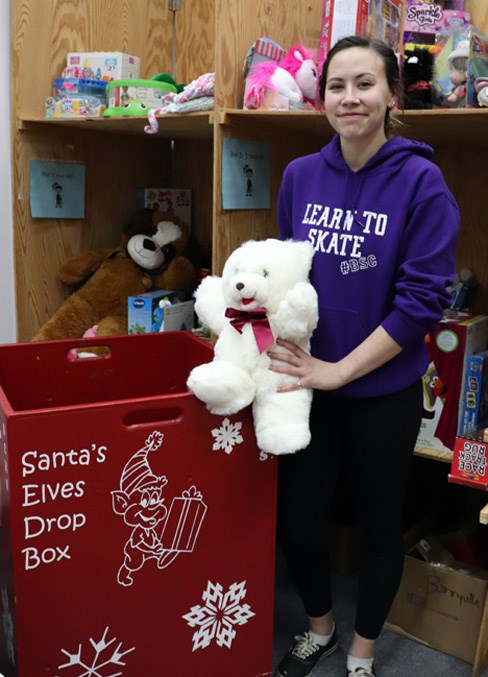 Kendra Moore, Grade 12 student, stands beside one of the big red donation boxes residents will see throughout the community.