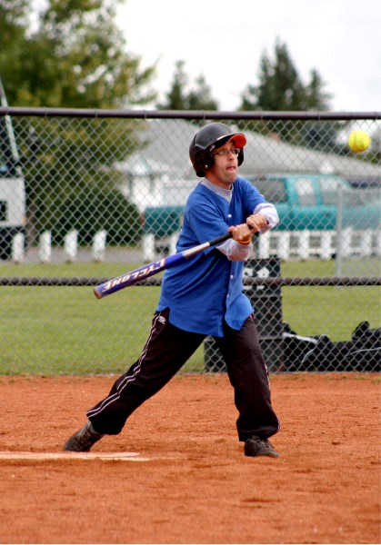 L.J. Buryn, a member of the St. Paul blue division team, takes a swing for the ball at the 24th annual Conrad Jean Slo-Pitch Tournament on Aug. 29.