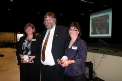 Northern Lights Library System board chair Larry Tiedemann recognized the efforts of renovation project manager Brigitte Sakaluk (left) and her assistant, Patty Mathiot, at