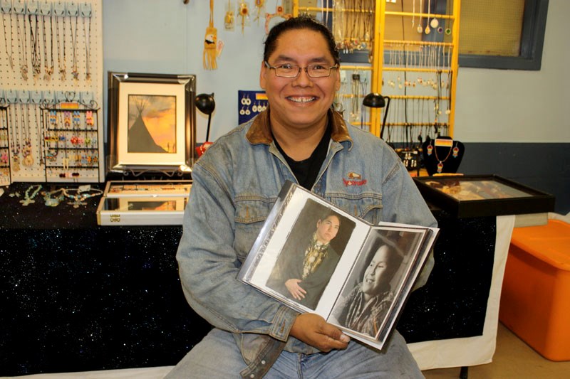 Samuel Bull displays some of his photography at the Fall Harvest fair in Goodfish Lake on Sept. 20.