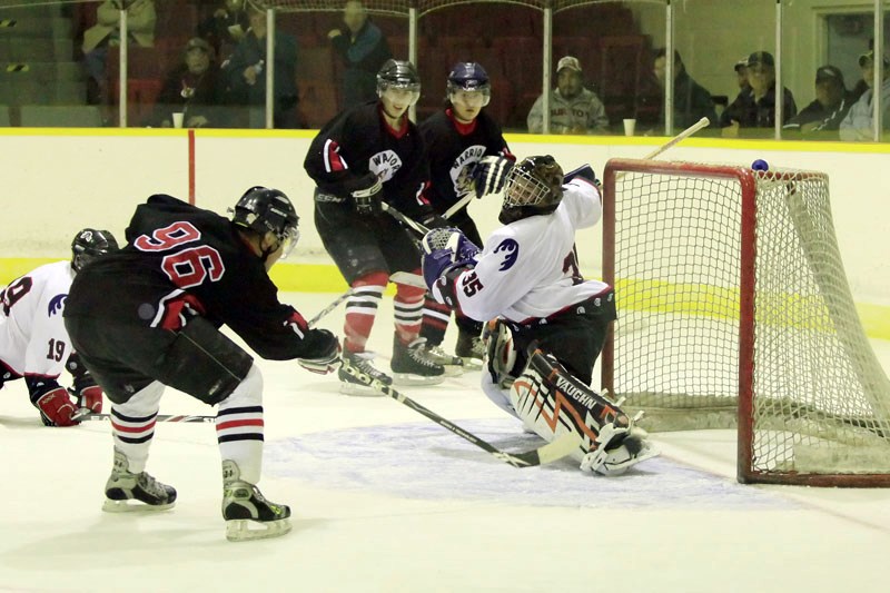 Warriors Jordan Moosewah&#8217;s (96) attempt at scoring in the second period is denied by Titans&#8217; Austin Hoetmer at Saddle Lake Warriors&#8217; Manitou Kihew arena on
