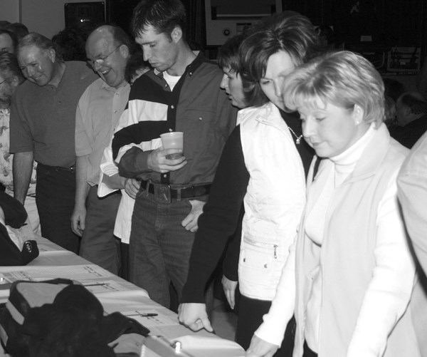 People peruse auction items at a past Ducks Unlimited dinner and auction event. The annual fundraiser is set to take place again this Saturday.