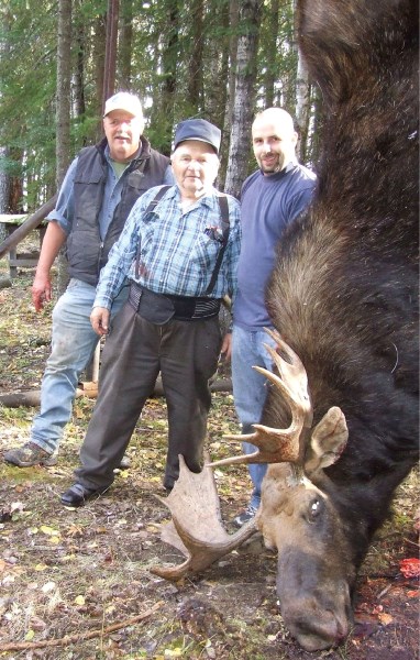 Adelard Bilodeau (centre) poses with son-in-law Omer Robert (left), grandson-in-law Jay Karba and the moose he shot recently. Bilodeau is 84-years-old and says this will be