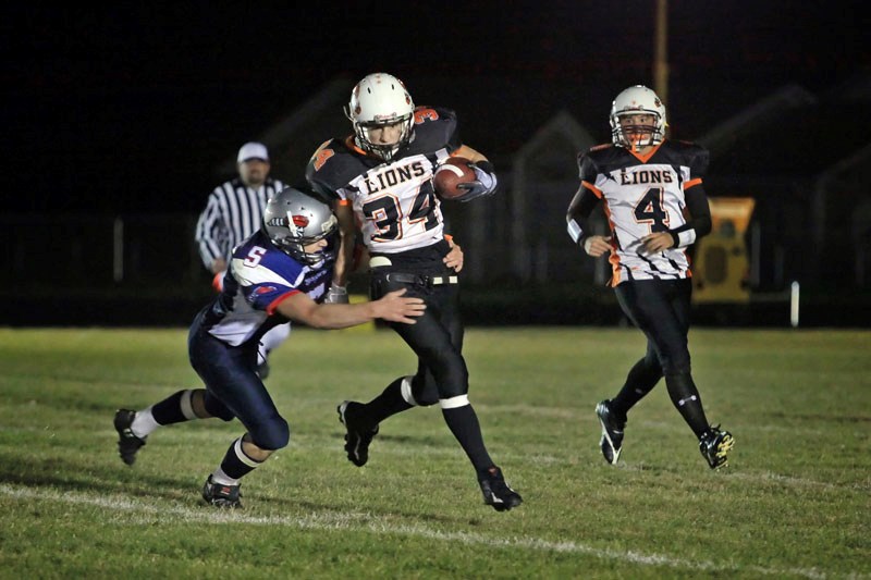 Dale Krankowsky (34) of the St. Paul Lions runs the ball during a game against the Voyageurs. Krankowsky was the only one to score a touchdown for the team in its Oct. 15