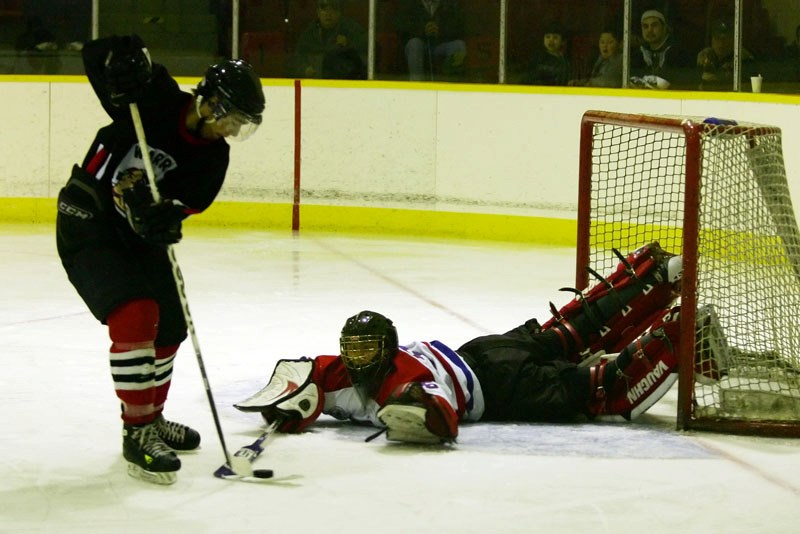 Carlen Lyle, goalie for the St. Paul Canadiens Junior B hockey team, protects his team&#8217;s goal against the Saddle Lake Warriors during the second period between the